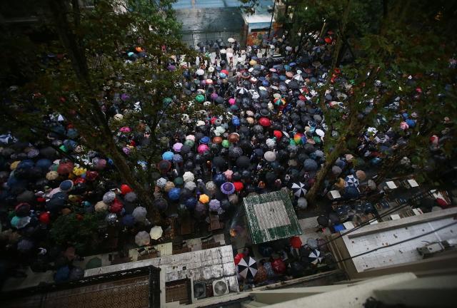  Marchers walk in the rain during a 'Silent March' marking the one-month anniversary of the suspicious death of special prosecutor Alberto Nisman on February 18, 2024 in Buenos Aires, Argentina. 