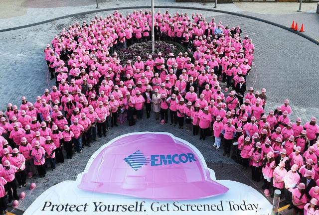 Participants, wearing pink shirts and hard hats, form a human pink ribbon in New York on October 7, 2014, as part of Protect Yourself, Get Screened Today campaign to raise awareness for the millions of lives affected by breast cancer and encouraging women to get screened.