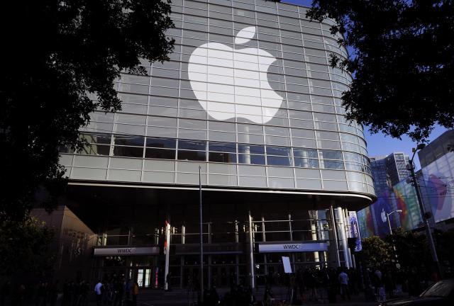 The Apple Inc. logo is displayed outside of the Moscone Center before the start of the Apple World Wide Developers Conference (WWDC) in San Francisco, California, U.S., on Monday, June 8, 2015. 