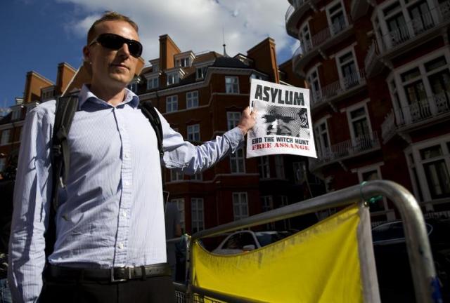 A supporter of Wikileaks founder Julian Assange holds a banner outside the Ecuadorian embassy in London as he marks three years since Assange claimed asylum in the embassy on June 19, 2015. WikiLeaks founder Julian Assange clocks up three years inside the Ecuadoran embassy in London today, after claiming that Swedish prosecutors cancelled a landmark meeting in his case earlier this week. A supporter of Wikileaks founder Julian Assange holds a banner outside the Ecuadorian embassy in London as he marks three years since Assange claimed asylum in the embassy on June 19, 2015. WikiLeaks founder Julian Assange clocks up three years inside the Ecuadoran embassy in London today, after claiming that Swedish prosecutors cancelled a landmark meeting in his case earlier this week.