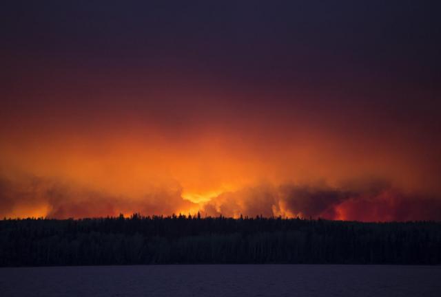 A massive wildfire rages Wednesday evening, May 4, 2016, near Anzac, Alberta, a hamlet 48 km southwest of Fort McMurray. A massive wildfire rages Wednesday evening, May 4, 2016, near Anzac, Alberta, a hamlet 48 km southwest of Fort McMurray.