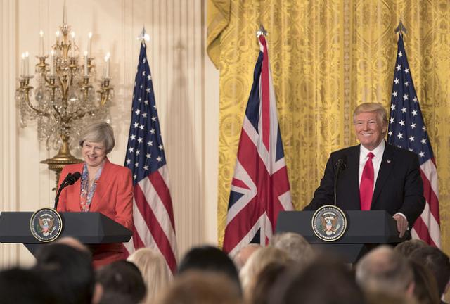 Embattled British PM Theresa May "nervously" looks up to U.S. President Donald Trump's visit.