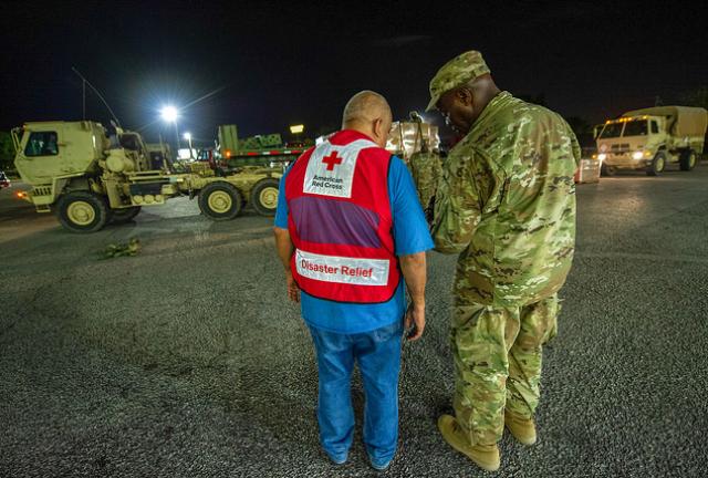 U.S. soldiers and Red Cross workers prepare to transport supplies to shelters for people evacuating from Hurricane Florence.