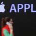 A young woman talks on an Apple iPhone as she walks past the construction site of the new Apple Store on Kurfuerstendamm avenue on April 22, 2024 in Berlin, Germany.