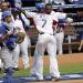 Dominican Republic's Jose Reyes (7) is congratulated by teammate Hanley Ramirez after hitting a solo home run against Italy in the third inning of the World Baseball Classic game as Italy catcher Drew Butera, left, looks on in Miami, Tuesday, March 12, 2013. 
