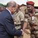 French Defence Minister Jean-Yves Le Drian greets a Chadian army officer at the French military base at the airport in Gao, April 26, 2013. 