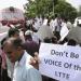 Sri Lankans hold placards while blocking a train carrying Channel 4’s British journalist Callum Macrae, in protest against a documentary made by him, in Anuradhapura, Sri Lanka, Wednesday, Nov. 13, 2013.