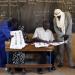 Election officials go through electoral lists trying to identify the voter at right, in a polling station set for Mali's parliamentary elections in Gao, Northern Mali, Sunday Nov. 24, 2013.