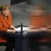 German Chancellor Angela Merkel, reflected through a pane of glass and who is seated due to an injury, gives a government declaration to outline the policy priorities of the new German coalition government of Christian Democrats and Social Democrats on January 29, 2024 in Berlin, Germany.