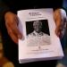 A man holds programs for people attending a memorial service for former South African President Nelson Mandela at St Peter's Cathedral on December 16, 2024 in Adelaide, Australia.