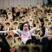 A handout picture released by the official website of Iranian Supreme Leader Ayatollah Ali Khamenei on February 17, 2024 shows women and a girl holding up portraits of him during a meeting in Tehran.