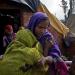 Saira (in green) is held by a relative while she cries during the funeral of her seven-month-old daughter, Shubnam, in the Malakpur relief camp January 23, 2024 in the Shamli District of Uttar Pradesh, India.