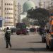 An Egyptian ambulance officer walks along a street as Egyptian police inspectors examine the scene of an exploded bus bomb on December 26, 2103, in Cairo, Egypt. Egyptian security forces reported a bomb planted on a public bus exploded by the campus of the Al Azhar University in Cairo's Nasr City on Thursday morning, wounding five people. 