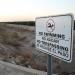 A no swimming sign is posted next to a dry irrigation canal on August 22, 2024 in Madera, California.