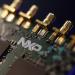Microprocessors sit on a circuit board displayed on the NXP Semiconductors NV pavilion at the Mobile World Congress in Barcelona, Spain, on Monday, March 2, 2015. 